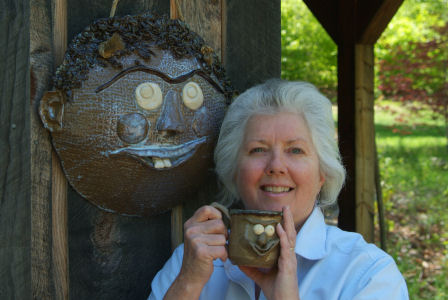 Carol Ann Cushman holding one of her pieces
